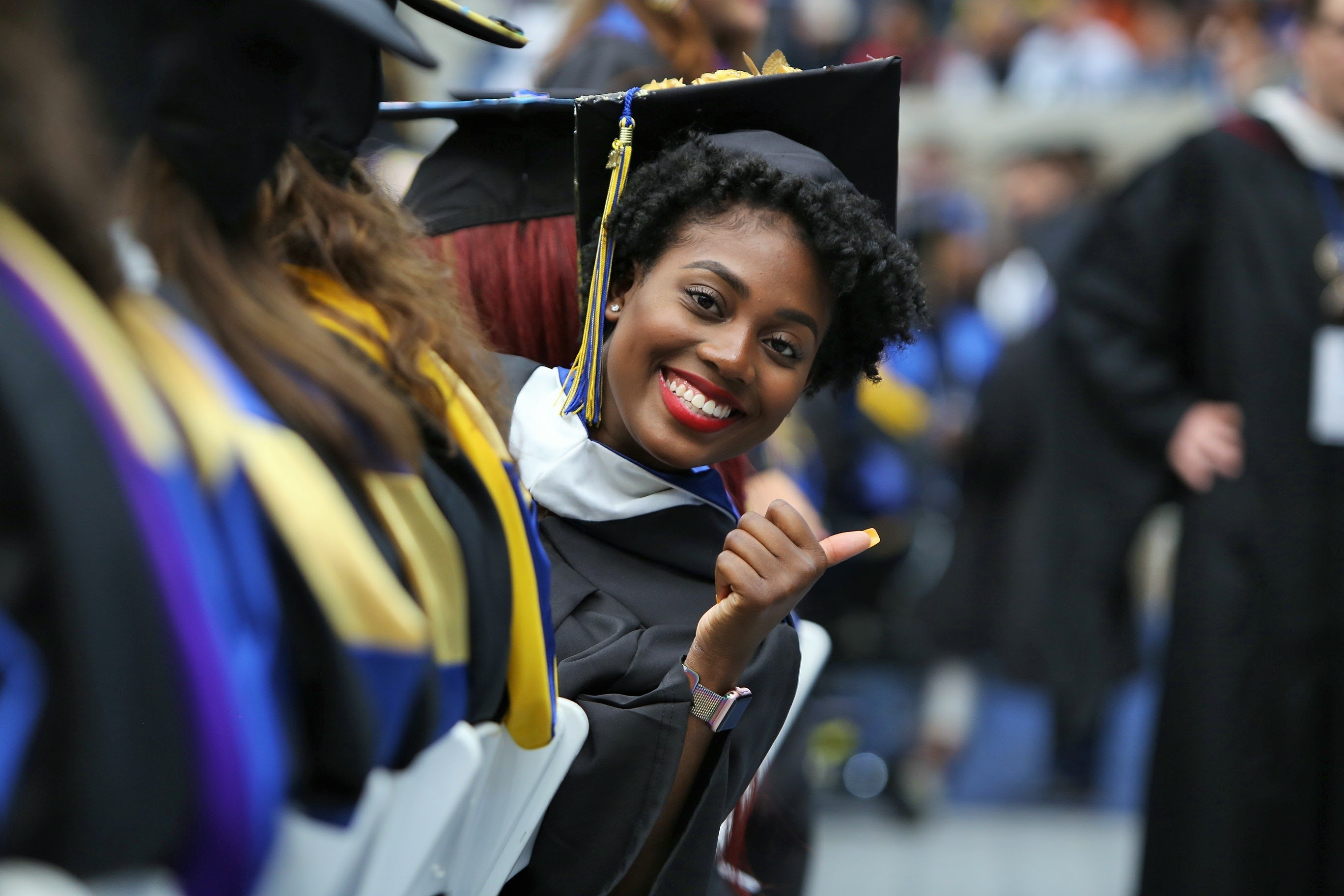 Student giving thumbs up at Commencement