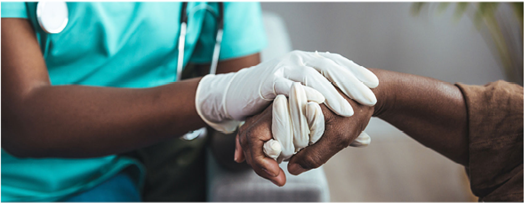 A nurse holding a patient's hand