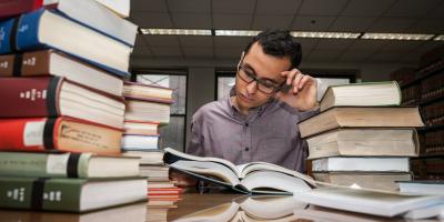 Person with books in library