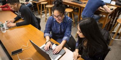 Two students with a laptop