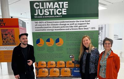 John Jay Faculty members in front of a Climate Justice poster